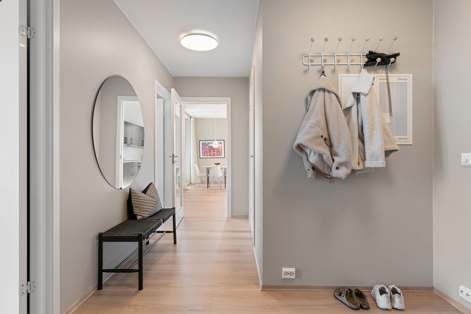 Boot room storage ideas with wooden coat hooks bench and open shelving